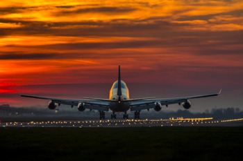 Aircraft landing at sunset