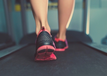 Woman running on a treadmill stock photo